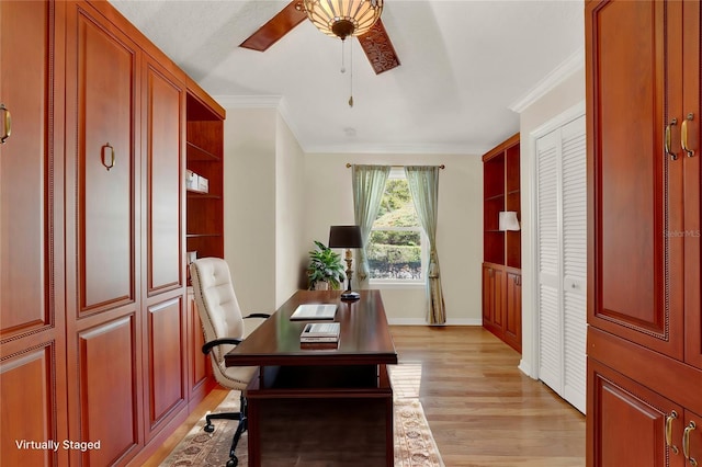 home office featuring baseboards, light wood finished floors, a ceiling fan, and crown molding