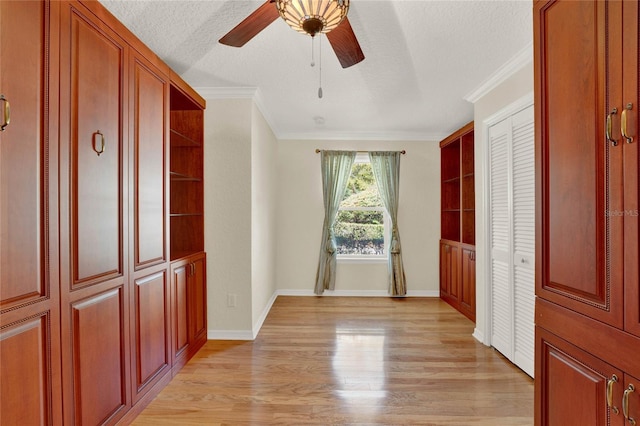 unfurnished bedroom featuring light wood-type flooring, ornamental molding, and a textured ceiling