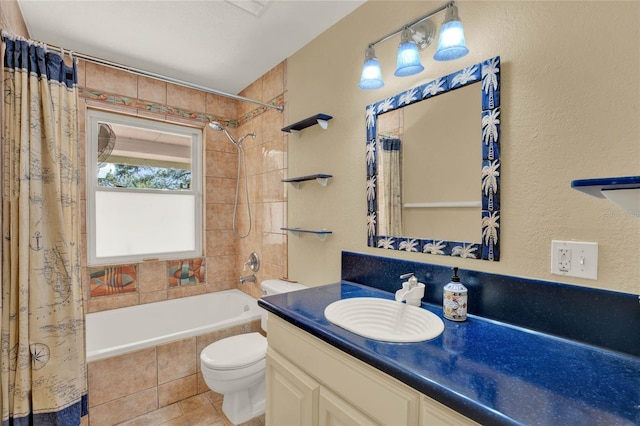 bathroom featuring tiled shower / bath, vanity, toilet, and tile patterned floors