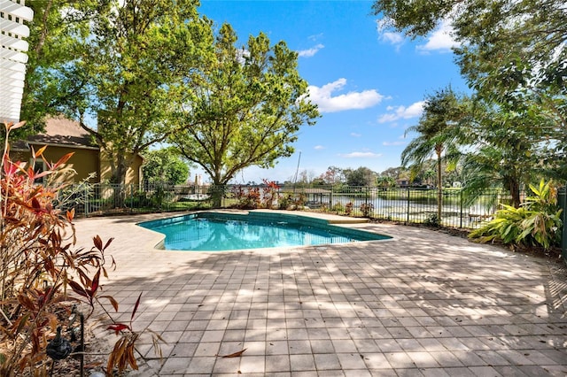 view of pool featuring a water view, a patio area, fence, and a fenced in pool