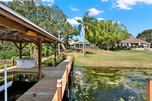 dock area with a water view and a lawn