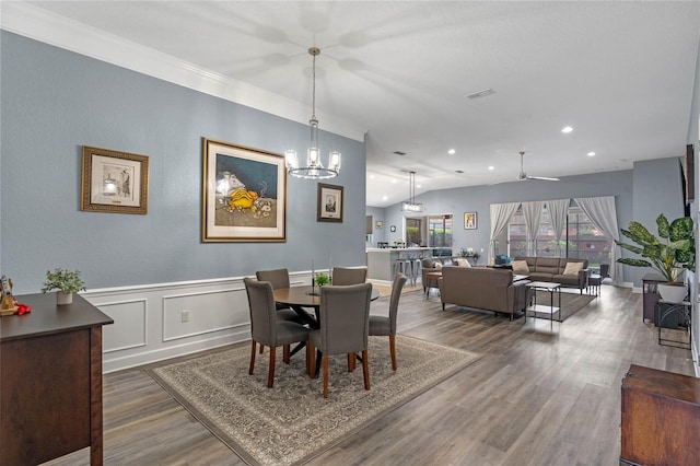 dining room featuring visible vents, dark wood finished floors, a wainscoted wall, vaulted ceiling, and recessed lighting