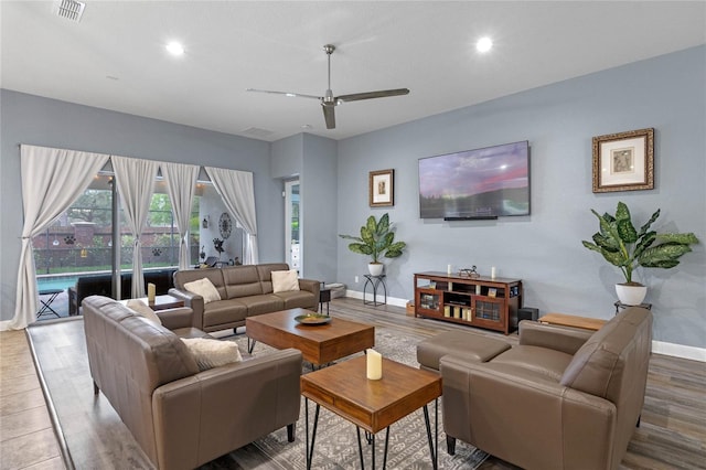 living room featuring baseboards, visible vents, ceiling fan, wood finished floors, and recessed lighting