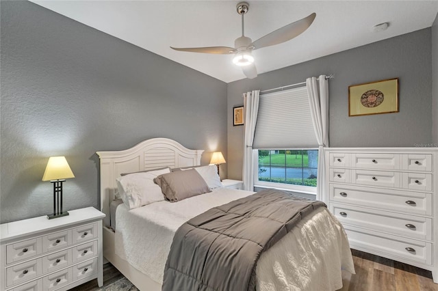 bedroom featuring ceiling fan and dark wood-type flooring