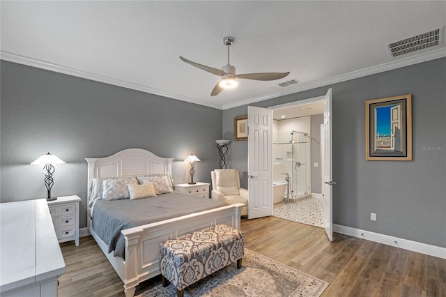 bedroom featuring baseboards, visible vents, crown molding, and wood finished floors