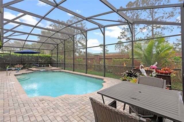 view of pool with a patio, a lanai, and a pool with connected hot tub