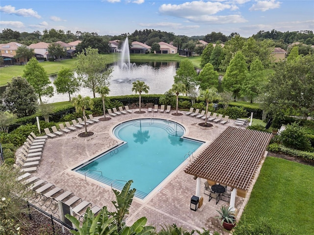 community pool with a water view and a patio area