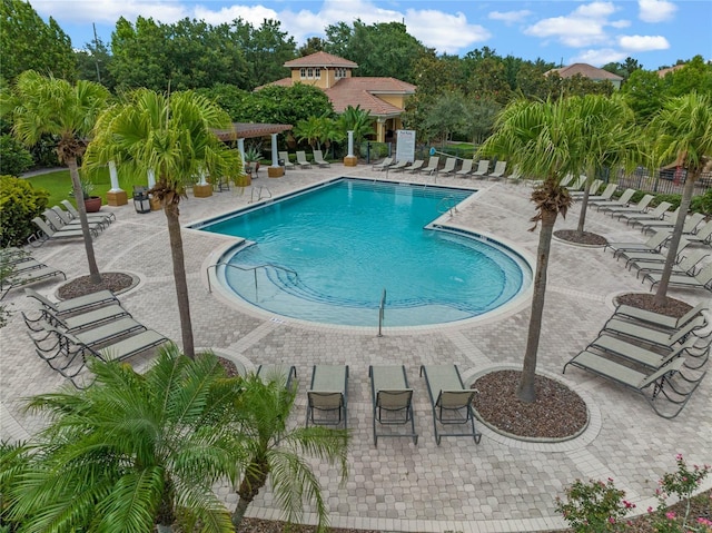 pool featuring a patio area and fence