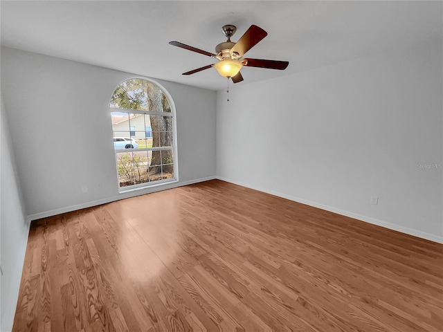 spare room featuring light hardwood / wood-style floors and ceiling fan