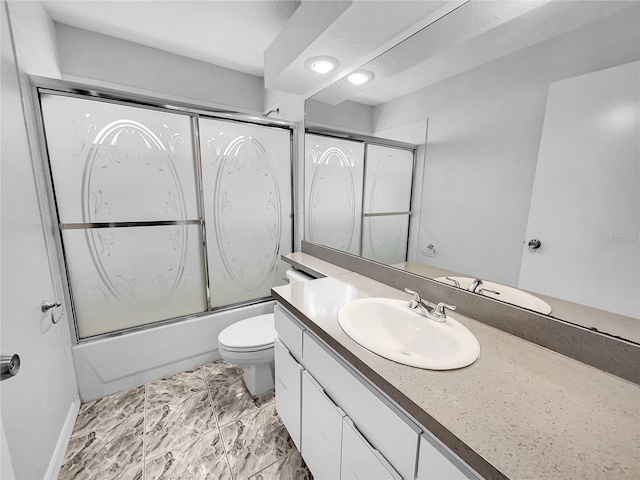 full bathroom featuring vanity, enclosed tub / shower combo, and toilet