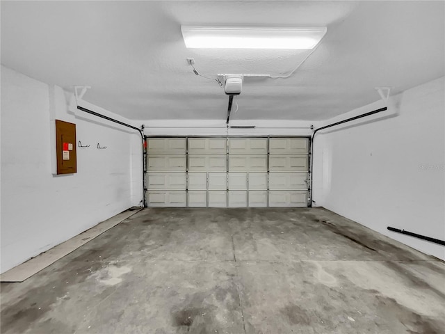 garage featuring a garage door opener and electric panel