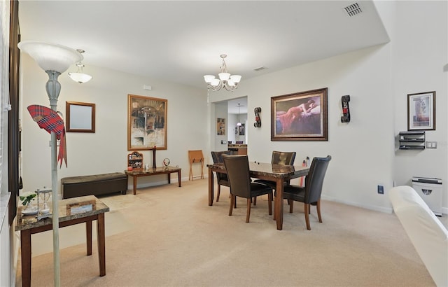 dining area with an inviting chandelier, baseboards, visible vents, and light colored carpet