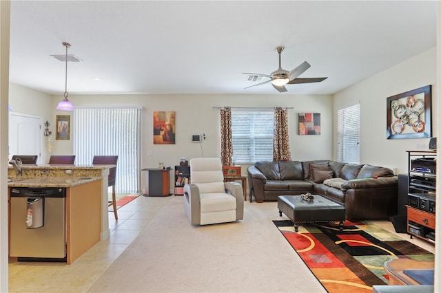 living area featuring visible vents, a ceiling fan, and light tile patterned flooring