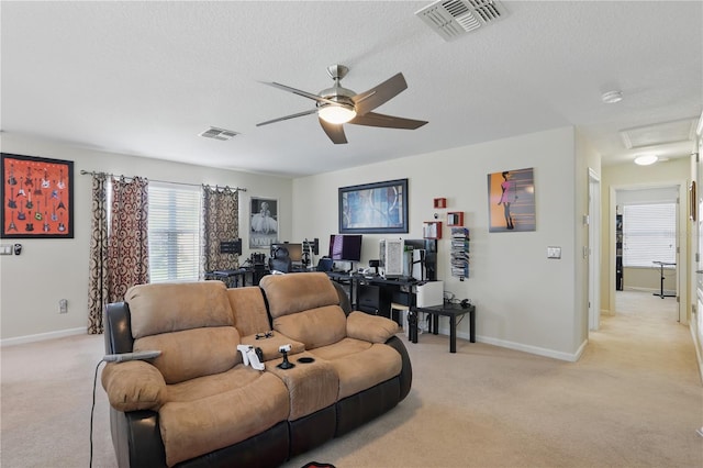 living room with light carpet, a textured ceiling, visible vents, and baseboards