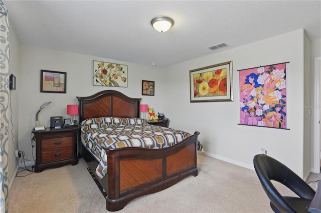 bedroom with a textured ceiling, baseboards, visible vents, and light colored carpet