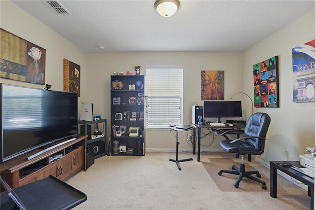 office featuring baseboards, visible vents, a textured ceiling, and light colored carpet