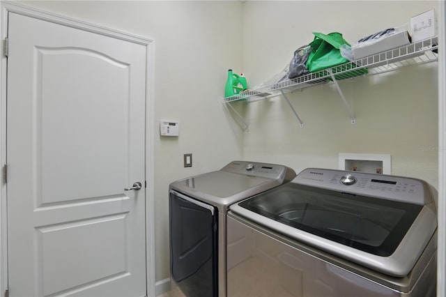 clothes washing area featuring laundry area and washing machine and dryer