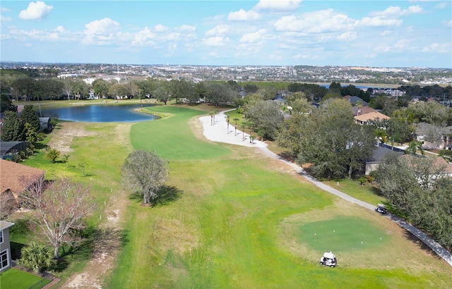 birds eye view of property with golf course view and a water view