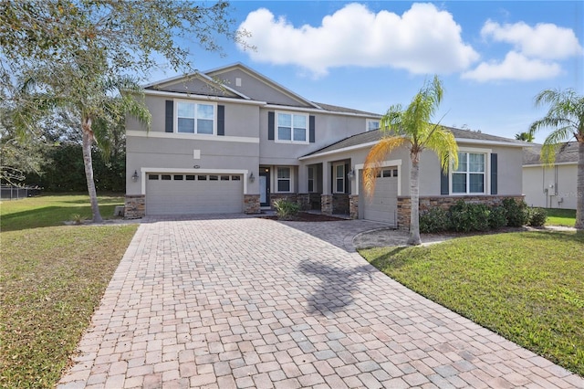 craftsman-style home with stone siding, decorative driveway, a front lawn, and stucco siding