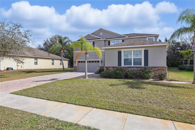 view of front of house with stucco siding, decorative driveway, and a front yard