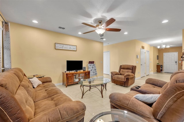 15506 Gemini Dr, Mascotte, FL 34753 - living room featuring ceiling fan with notable chandelier and light tile patterned flooring