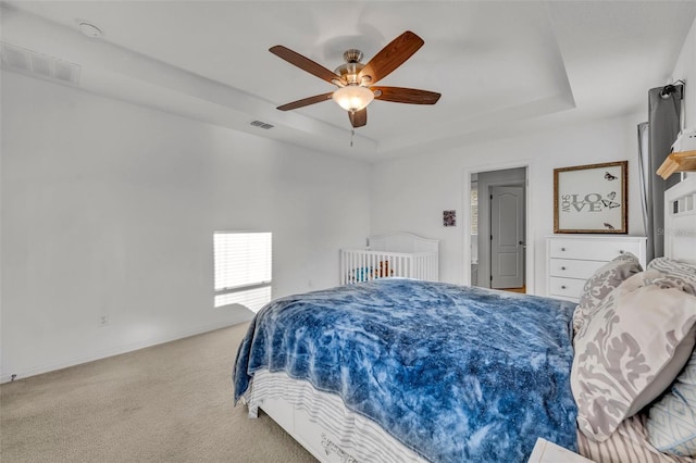 15506 Gemini Dr, Mascotte, FL 34753 - carpeted bedroom with a raised ceiling and ceiling fan