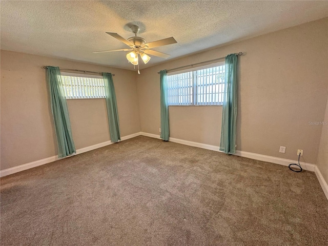 carpeted empty room featuring a textured ceiling, baseboards, and ceiling fan