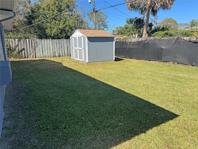 view of yard with an outdoor structure, a storage shed, and a fenced backyard