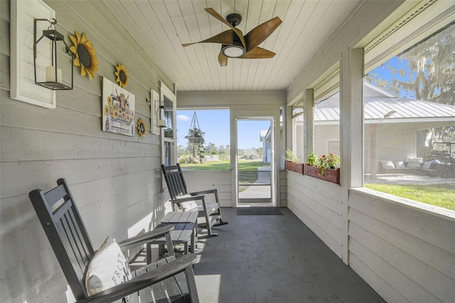 sunroom / solarium with ceiling fan and wood ceiling