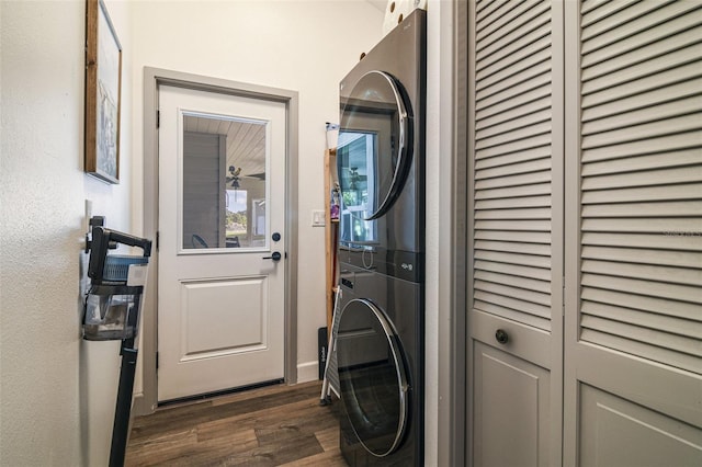 clothes washing area with laundry area, dark wood-style flooring, and stacked washing maching and dryer