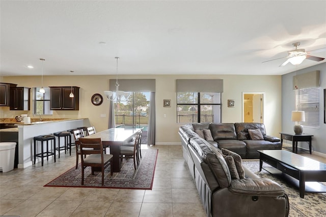 living room featuring sink, plenty of natural light, and light tile patterned flooring