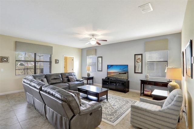 tiled living room with ceiling fan