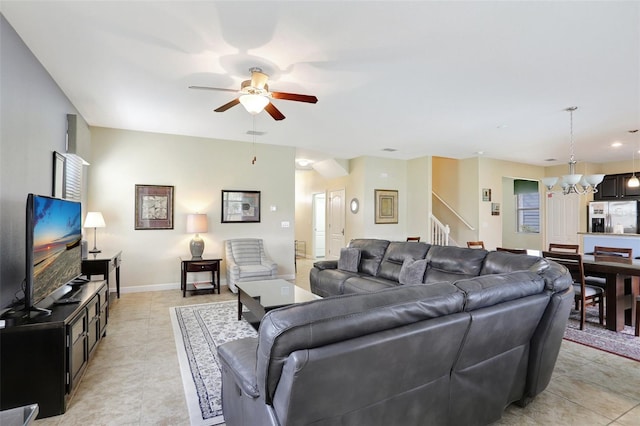 living room with light tile patterned floors and ceiling fan with notable chandelier