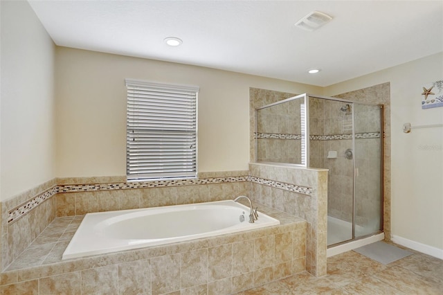 bathroom with independent shower and bath and tile patterned flooring