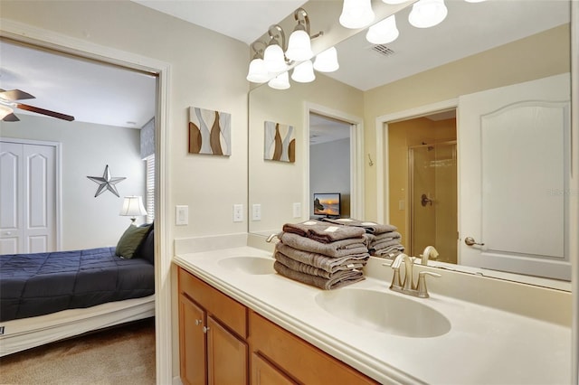 bathroom featuring walk in shower, ceiling fan, and vanity