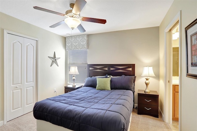 bedroom with light colored carpet, a closet, and ceiling fan