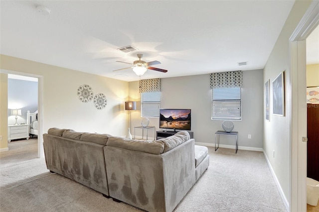 living room featuring ceiling fan and light colored carpet