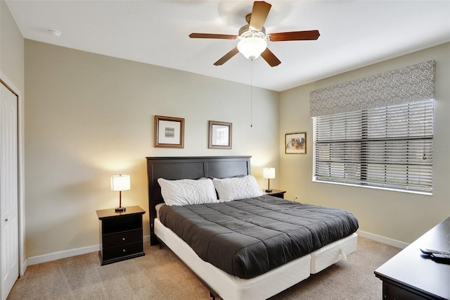 bedroom with light carpet and ceiling fan