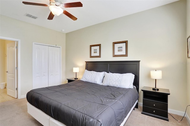 bedroom with light carpet, ceiling fan, and a closet