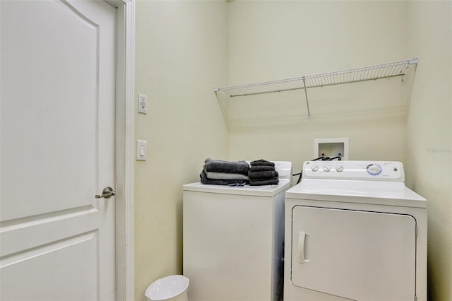 clothes washing area featuring washer and clothes dryer