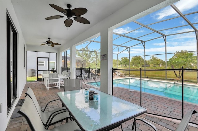 sunroom with a patio and ceiling fan