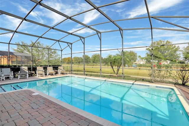 view of swimming pool featuring a lanai and a patio area