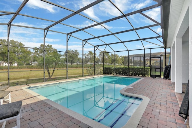 view of swimming pool featuring a patio, a lanai, and a yard