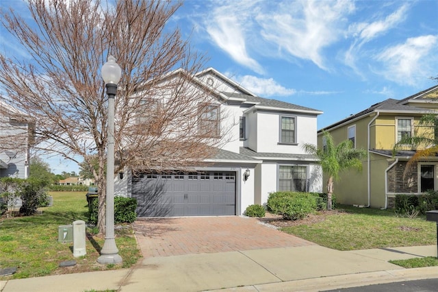 view of front of property with a garage and a front lawn