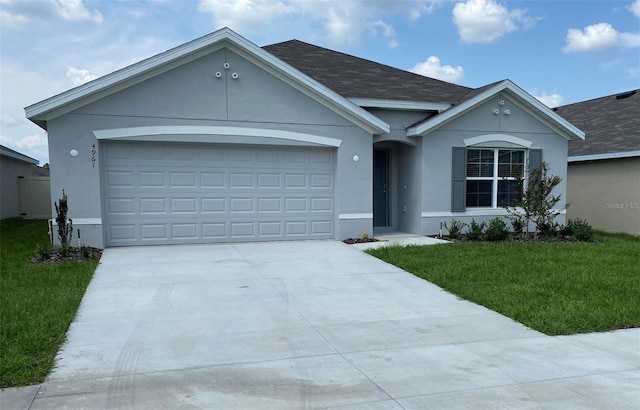 ranch-style house with a garage and a front yard