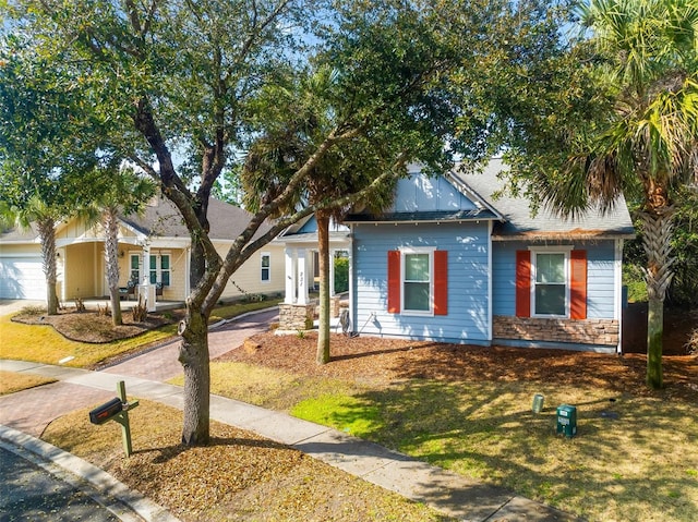 view of front of home with a garage and a front yard