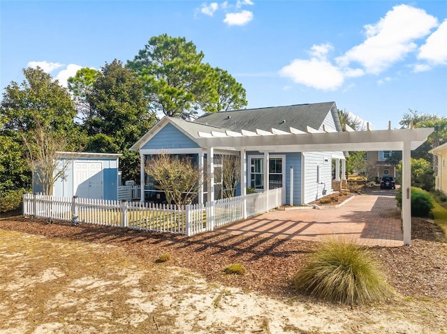 231 Turtle Cv, Panama City Beach, FL 32413 - rear view of property with a shed and a pergola