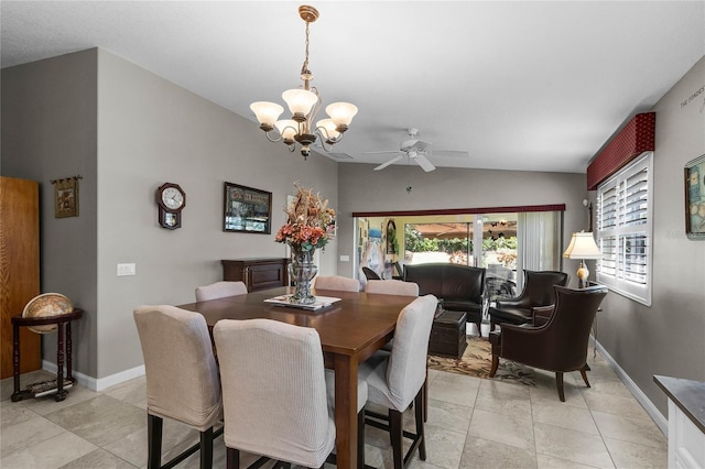 dining room featuring lofted ceiling and ceiling fan with notable chandelier