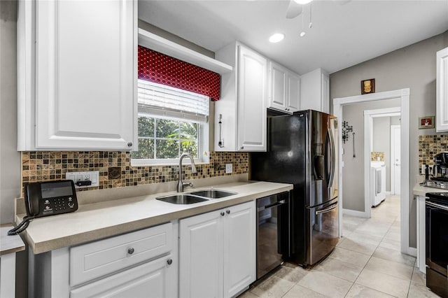 kitchen featuring sink, light tile patterned floors, stainless steel appliances, tasteful backsplash, and white cabinets