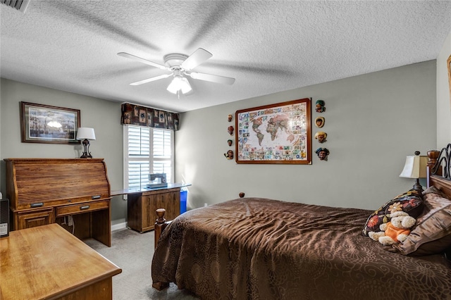 carpeted bedroom with ceiling fan and a textured ceiling